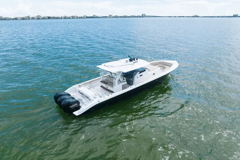 Pirates Bight Yacht Photos Pics Aerial view of 2019 Pursuit 408 boat on open water.