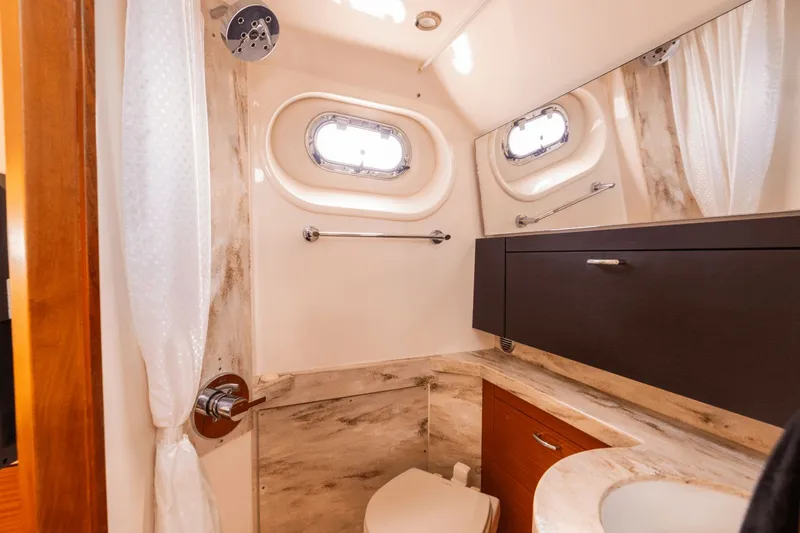 Pirates Bight Yacht Photos Pics Luxurious 2019 Pursuit 408 yacht bathroom with modern fixtures and porthole windows.