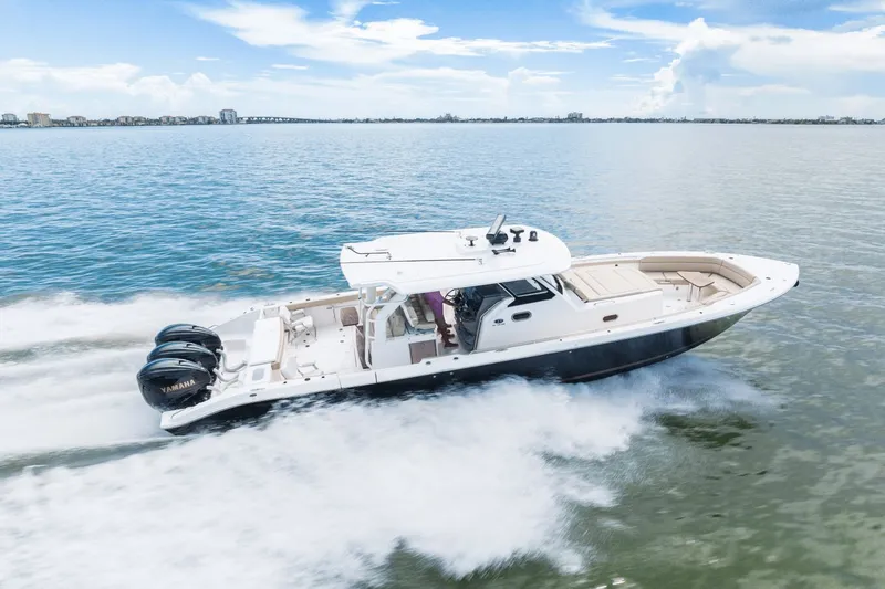 Pirates Bight Yacht Photos Pics 2019 Pursuit 408 boat cruising on open water, featuring triple Yamaha engines.