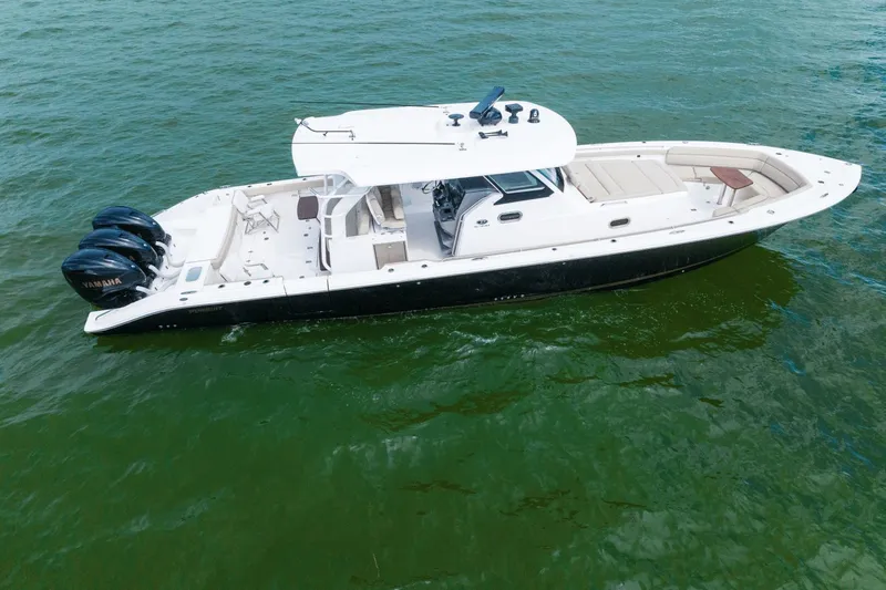 Pirates Bight Yacht Photos Pics 2019 Pursuit 408 boat with triple Yamaha engines on green water.