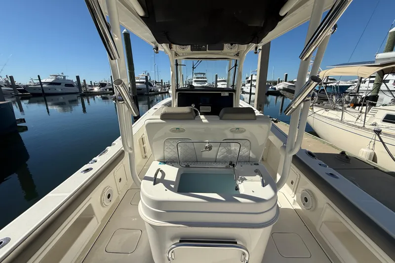  Yacht Photos Pics 2021 World Cat 295 CC boat interior at marina, showcasing seating and storage.
