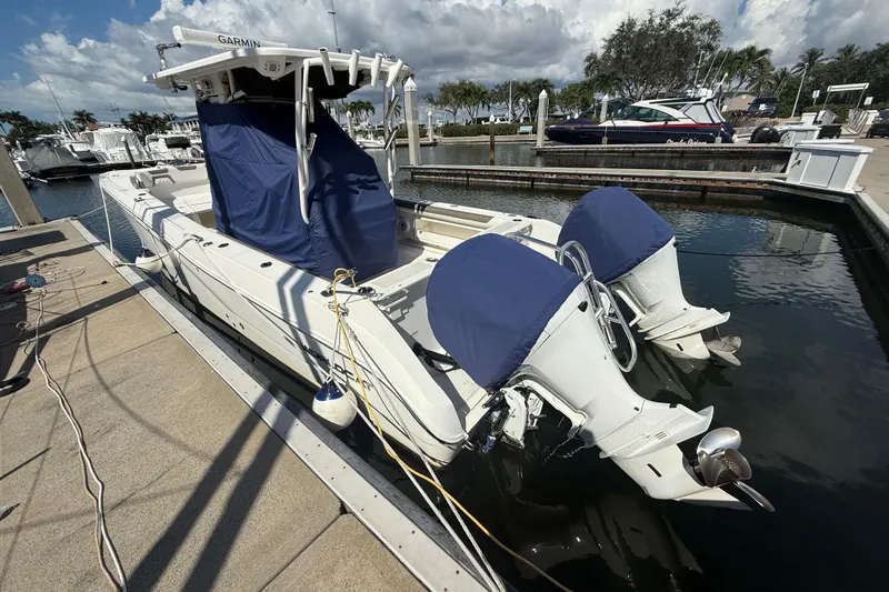  Yacht Photos Pics 2021 World Cat 295 CC boat docked, featuring twin engines with blue covers.