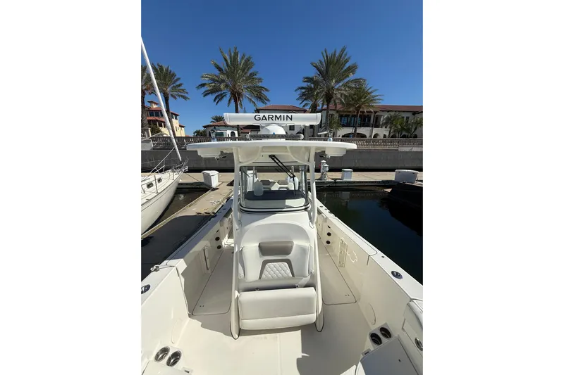  Yacht Photos Pics 2021 World Cat 295 CC boat docked, featuring Garmin equipment, palm trees in background.