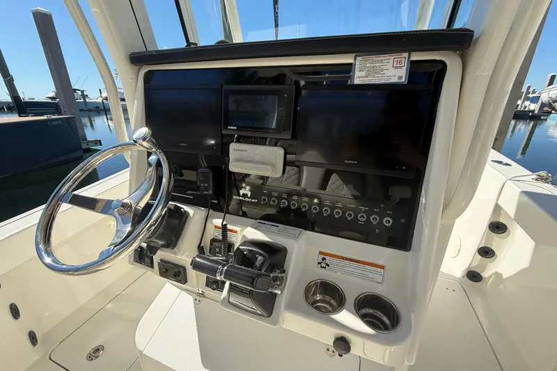  Yacht Photos Pics 2021 World Cat 295 CC boat dashboard with steering wheel and navigation controls.