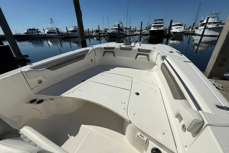  Yacht Photos Pics 2021 World Cat 295 CC boat interior at marina, showcasing spacious seating and sleek design.