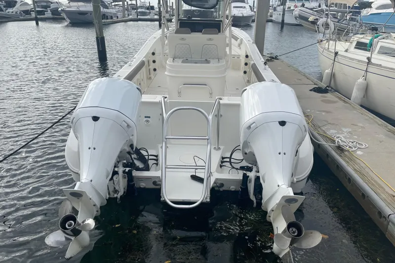 Yacht Photos Pics 2021 World Cat 295 CC boat with dual outboard engines docked at marina.