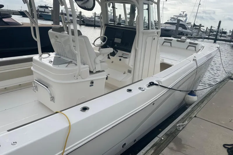  Yacht Photos Pics 2021 World Cat 295 CC boat docked at marina, showcasing sleek design and spacious deck.