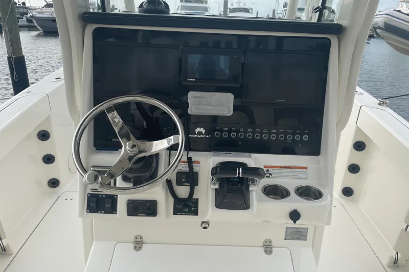  Yacht Photos Pics 2021 World Cat 295 CC boat dashboard with steering wheel and control panel.