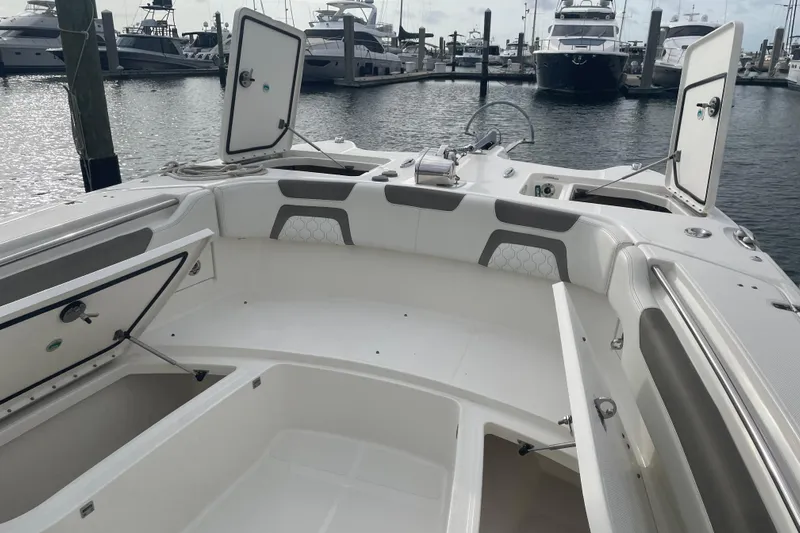  Yacht Photos Pics 2021 World Cat 295 CC boat interior with open storage compartments at marina.