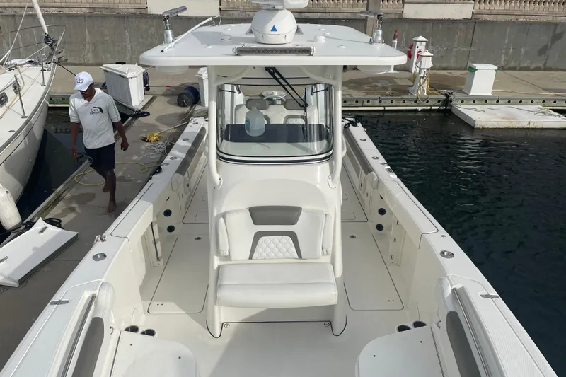  Yacht Photos Pics 2021 World Cat 295 CC boat docked, featuring spacious seating and modern design.