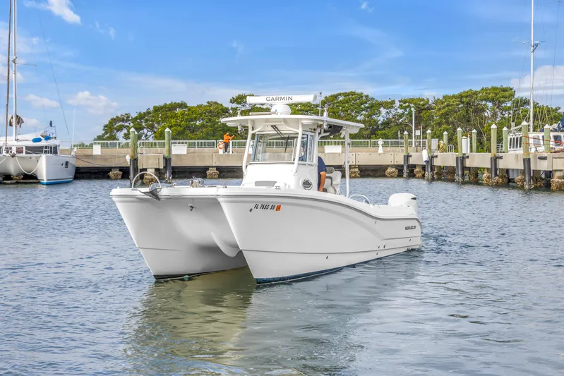  Yacht Photos Pics 2021 World Cat 295 CC boat docked in a marina under a clear blue sky.