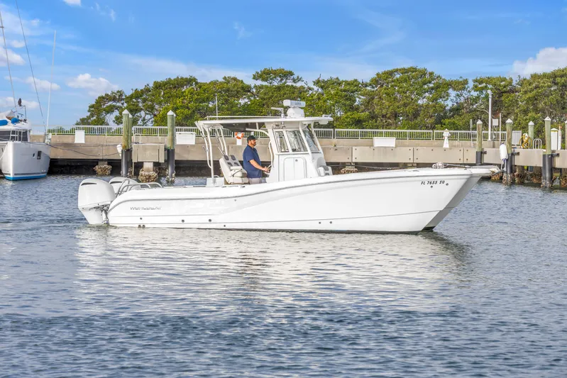  Yacht Photos Pics 2021 World Cat 295 CC boat docked in a marina under a clear blue sky.