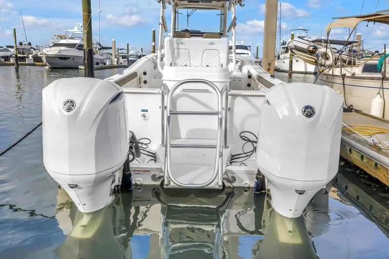  Yacht Photos Pics 2021 World Cat 295 CC boat with dual outboard engines docked at marina.