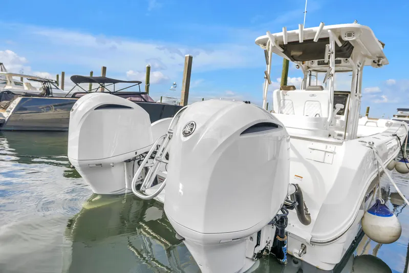  Yacht Photos Pics 2021 World Cat 295 CC boat with dual outboard engines docked in marina.