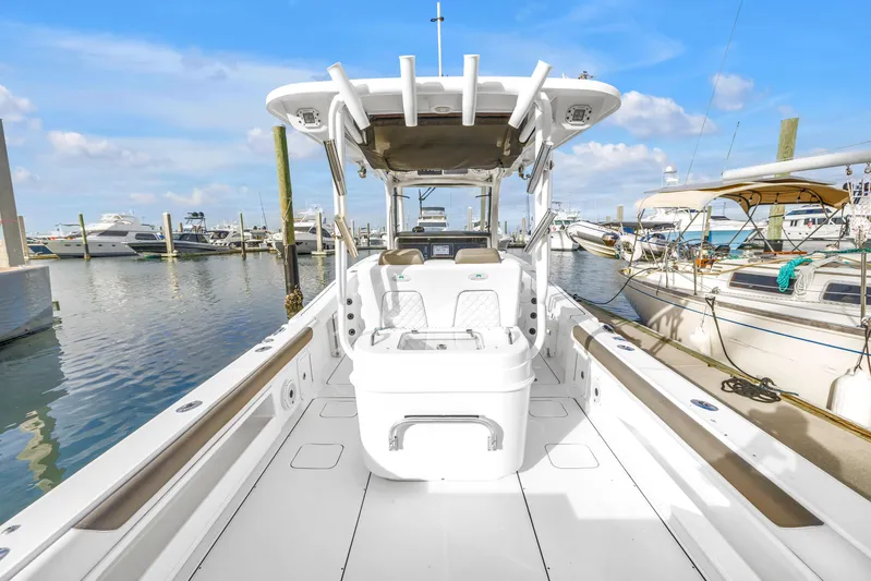  Yacht Photos Pics 2021 World Cat 295 CC boat docked at marina, clear sky, calm water.