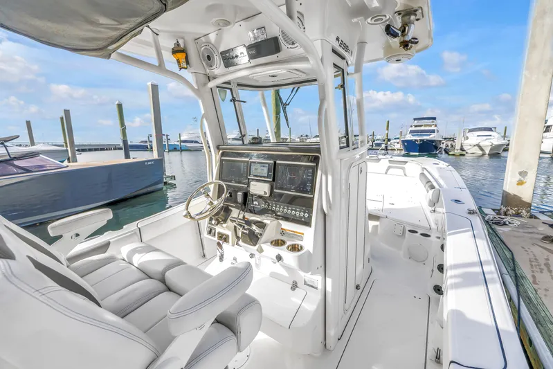  Yacht Photos Pics 2021 World Cat 295 CC boat interior at marina, featuring helm and seating.