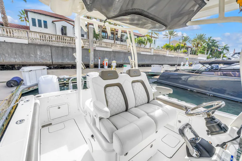  Yacht Photos Pics 2021 World Cat 295 CC boat interior with luxurious seating at a marina.