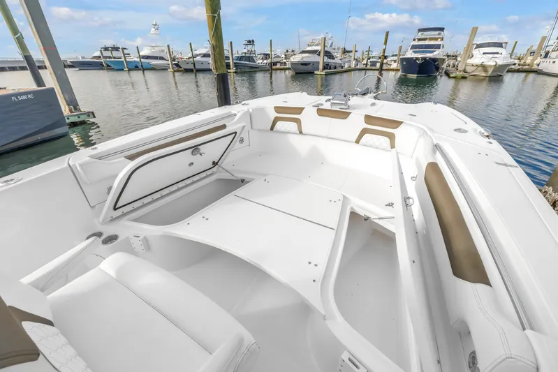  Yacht Photos Pics 2021 World Cat 295 CC boat interior at marina, featuring spacious seating and storage.