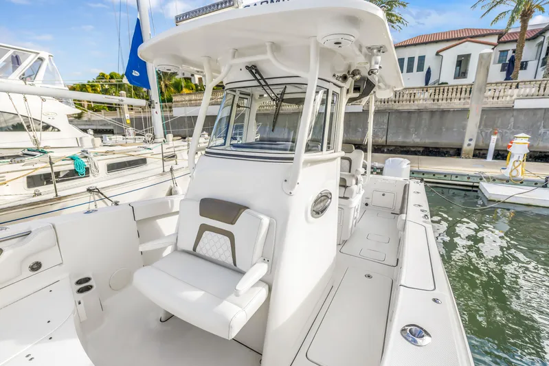  Yacht Photos Pics 2021 World Cat 295 CC boat docked, featuring spacious seating and modern design.