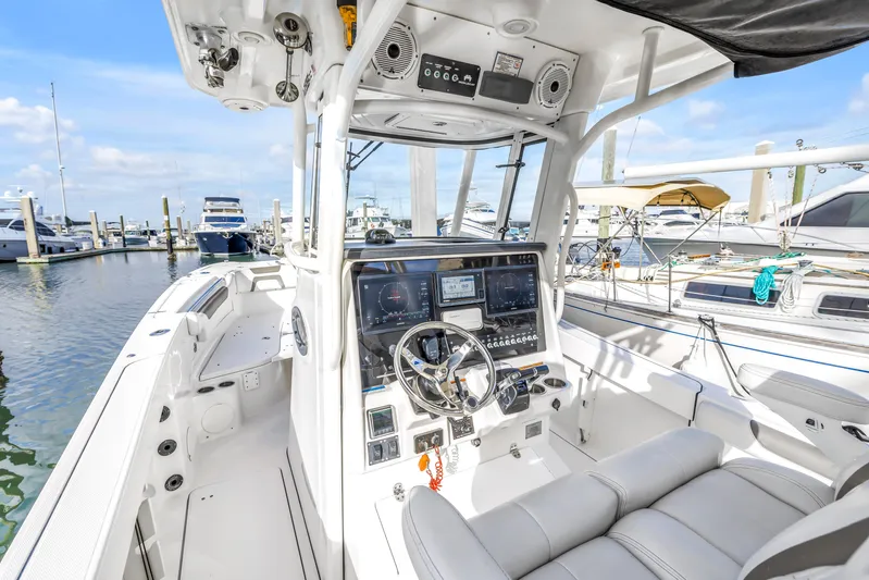  Yacht Photos Pics 2021 World Cat 295 CC boat interior with modern dashboard at marina.