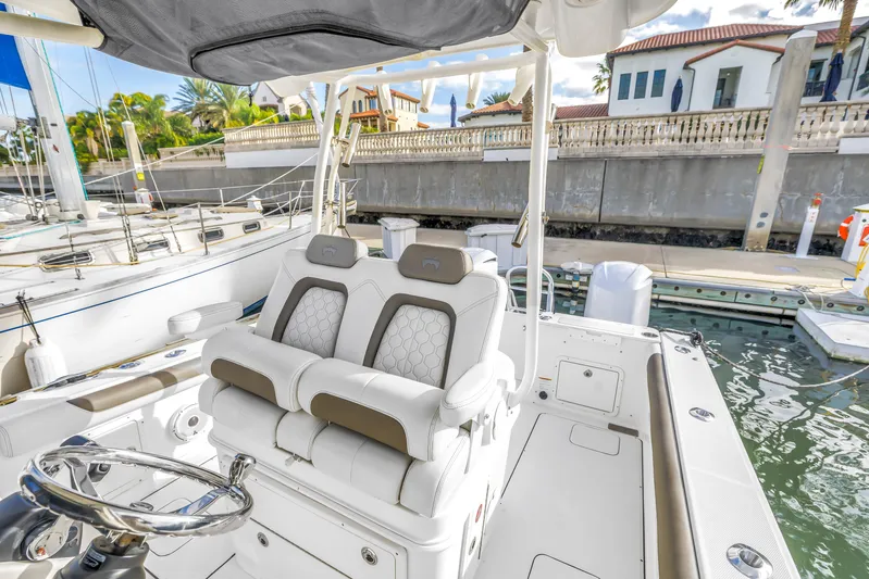  Yacht Photos Pics 2021 World Cat 295 CC boat interior with luxurious seating at a marina.