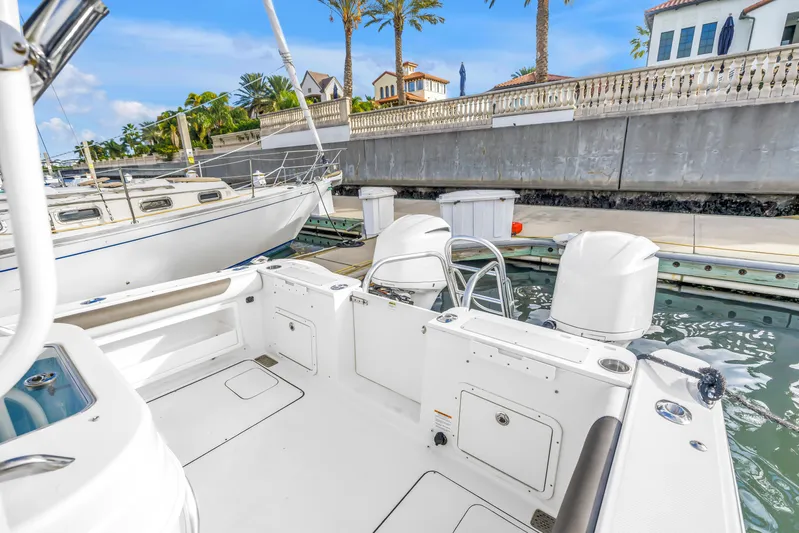  Yacht Photos Pics 2021 World Cat 295 CC boat docked at a marina with clear skies.