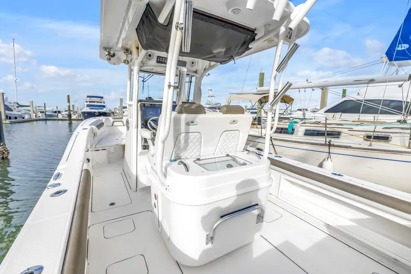  Yacht Photos Pics 2021 World Cat 295 CC boat interior at marina, showcasing seating and helm.