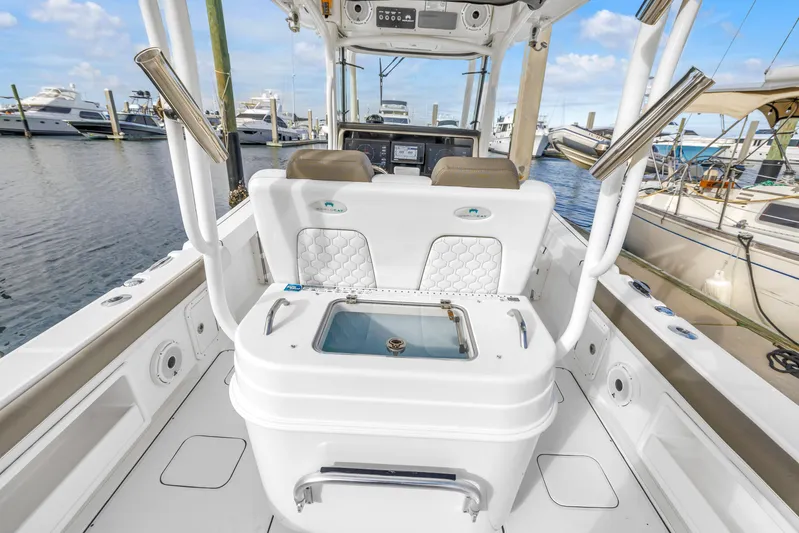  Yacht Photos Pics 2021 World Cat 295 CC boat interior with seating and storage, docked at marina.