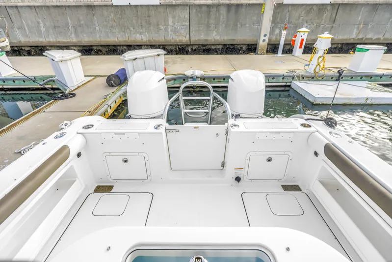  Yacht Photos Pics 2021 World Cat 295 CC boat interior at dock, showcasing spacious seating and storage.