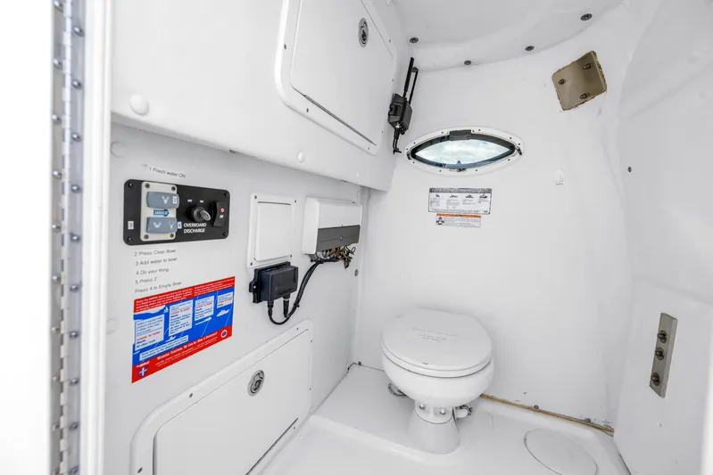  Yacht Photos Pics 2021 World Cat 295 CC boat interior bathroom with toilet and control panel.
