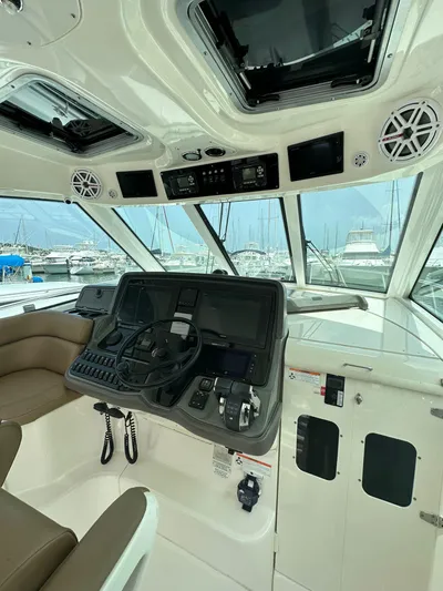  Yacht Photos Pics 2010 Boston Whaler 345 Conquest helm with modern controls and panoramic marina view.