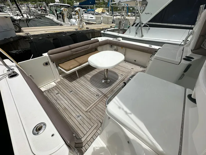  Yacht Photos Pics 2010 Boston Whaler 345 Conquest boat deck with seating and table.