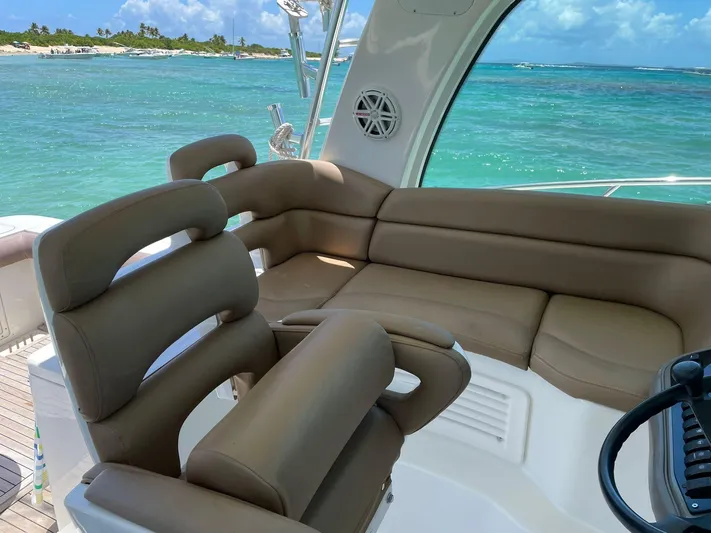  Yacht Photos Pics 2010 Boston Whaler 345 Conquest interior with plush seating, overlooking turquoise ocean waters.