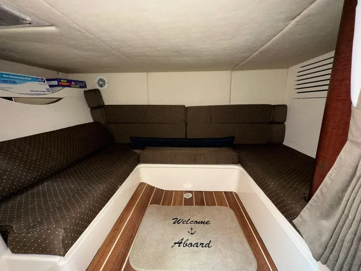  Yacht Photos Pics Interior cabin of 2010 Boston Whaler 345 Conquest with cozy seating and "Welcome Aboard" mat.
