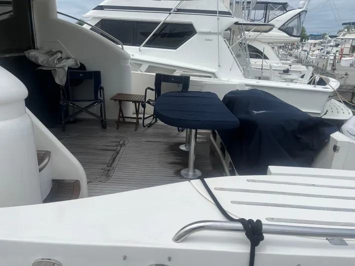 C Glass Yacht Photos Pics Deck of a 2000 Princess 65 M/Y yacht with seating and table.