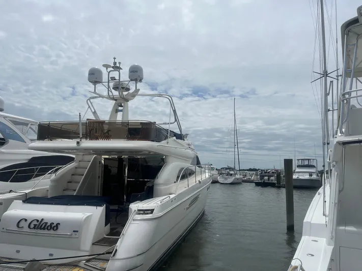 C Glass Yacht Photos Pics Luxury yacht Princess 65 M/Y 2000 docked at marina under cloudy sky.