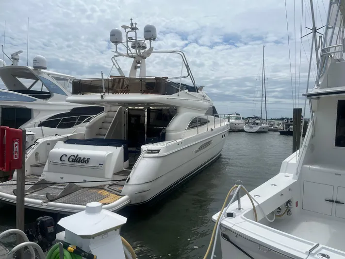 C Glass Yacht Photos Pics Luxury yacht Princess 65 M/Y 2000 docked at marina under cloudy sky.