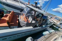 2022 Saxdor 320 GTO boat with Twin Mercury 300 V8 engines docked at marina.