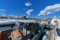 2022 Saxdor 320 GTO with Twin Mercury 300 V8 engines docked at a marina.
