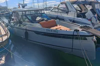 2022 Saxdor 320 GTO boat docked in marina, featuring Twin Mercury 300 V8 engines.