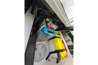 Storage compartment in 2022 Saxdor 320 GTO with organized equipment and safety gear.