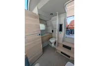 Interior of 2022 Saxdor 320 GTO boat, featuring modern bathroom and wooden cabinetry.