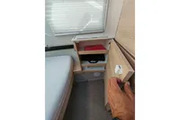 Interior of 2022 Saxdor 320 GTO, featuring a compact wooden storage cabinet.