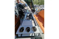 2022 Saxdor 320 GTO boat interior with sink, controls, and orange seating.