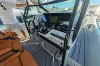 2022 Saxdor 320 GTO cockpit with modern controls and leather seating, docked at marina.