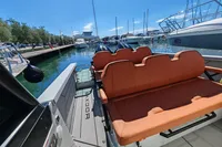 2022 Saxdor 320 GTO boat with twin Mercury 300 V8 engines docked at marina.
