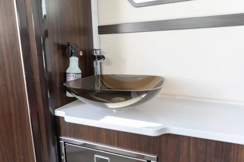  Yacht Photos Pics Modern sink area in 2023 Edgewater 370CC boat with sleek design and wood accents.
