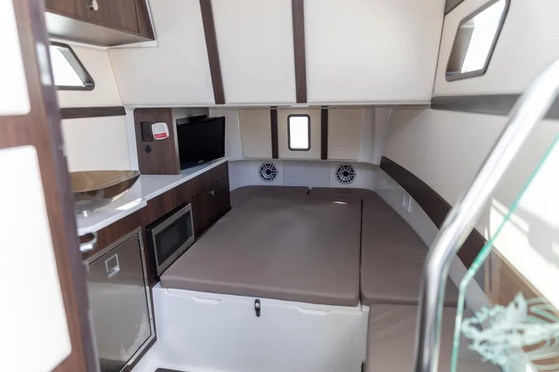 Yacht Photos Pics Luxurious interior of 2023 Edgewater 370CC boat with modern amenities and comfortable seating.