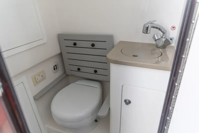  Yacht Photos Pics 2023 Edgewater 370CC boat bathroom with toilet and sink.
