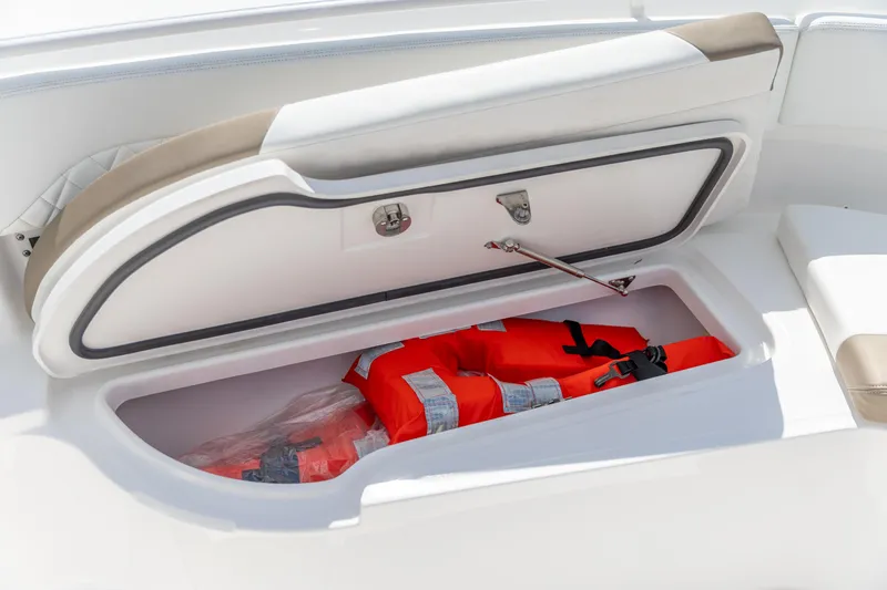  Yacht Photos Pics Storage compartment with life jackets on 2023 Edgewater 370CC boat.